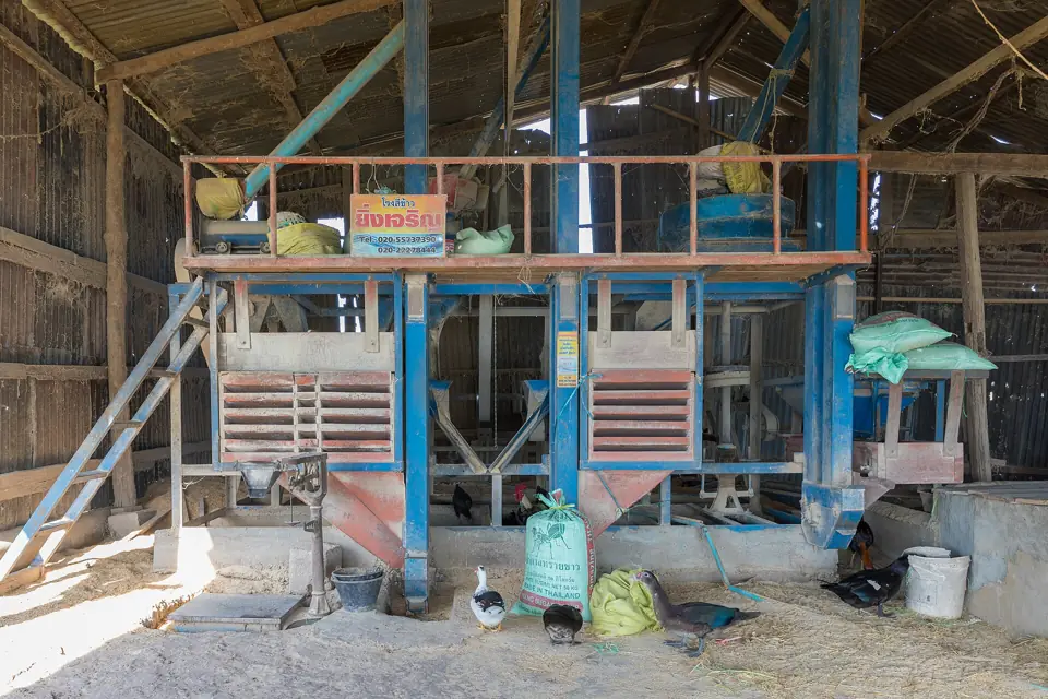Rice milling machinery inside a rice mill building