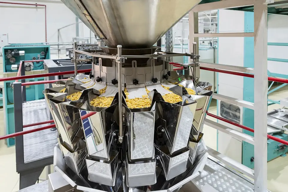 A multihead weigher portioning dried pasta in a packaging line